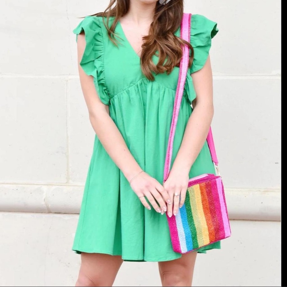Green babydoll dress with ruffle sleeves and zipper back. Size: S NEVER WORN